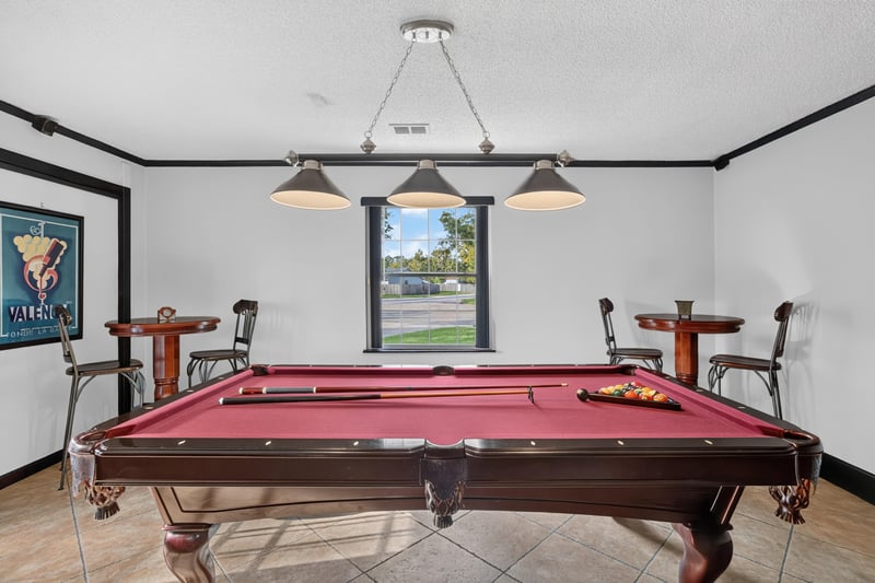 Pool table with pendant lighting at 6931 Cane Grass Ln E, Jacksonville, FL 32244