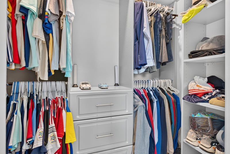 Closet with built-in shelving and hanging rods at 22 Azura Point