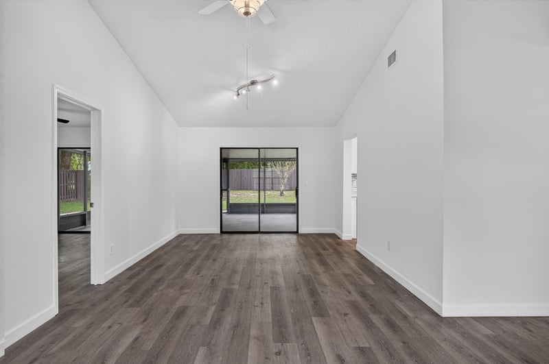 Living room with wood floor and sliding glass door at 551 Deltona Blvd, St. Augustine, FL 32086