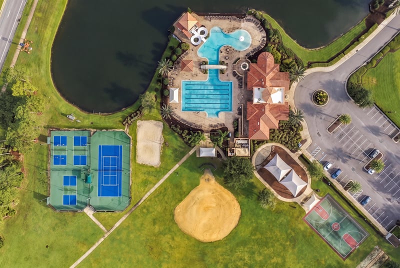 Aerial view of tennis courts and clubhouse pool in Murabella