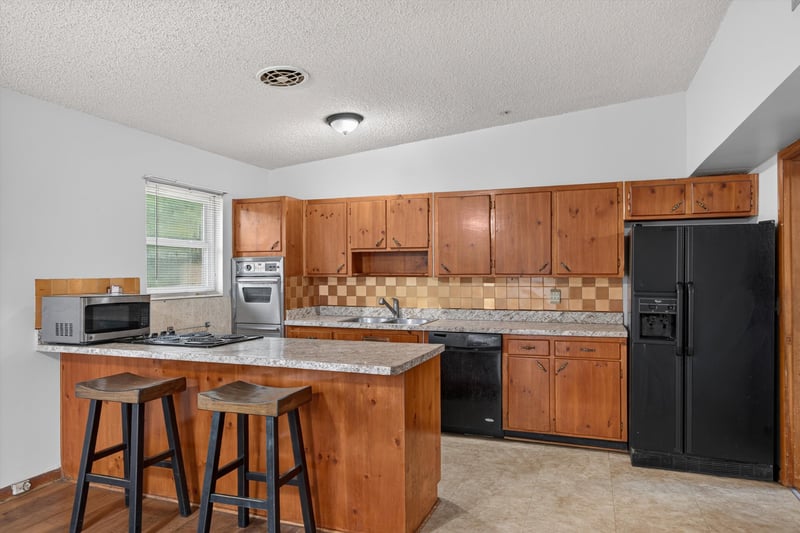 Kitchen with tile backsplash and cabinets at 11462 Elane Dr, Jacksonville, FL