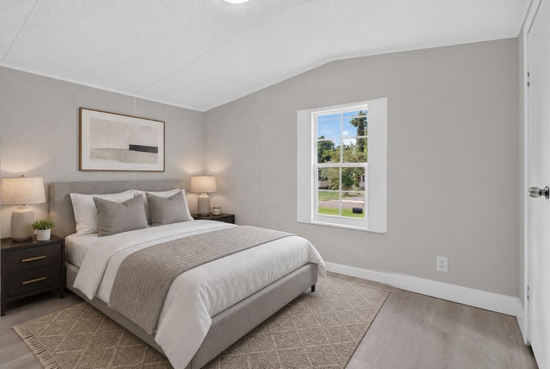 Bedroom staged with bed and artwork at 4565 Appleton Ave, Jacksonville, FL