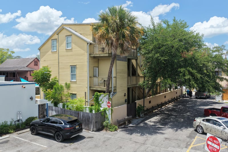 Yellow building facade with upper-level balcony and landscaping at 29 Cuna St, St. Augustine, FL 32084
