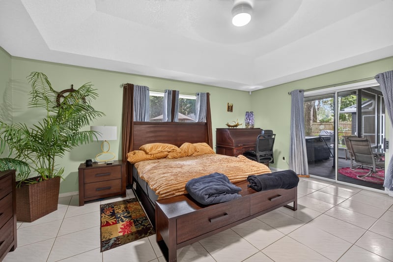 Primary bedroom with sliding doors to patio at 1346 Gately Ct, Jacksonville, FL 32225