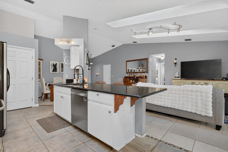 Kitchen island with white cabinets at 13020 Medford Ln, Jacksonville, FL 32225