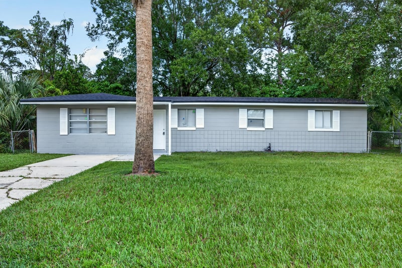 Front exterior with driveway and shade trees at 6745 Jack Horner Ln, Jacksonville, FL 32210