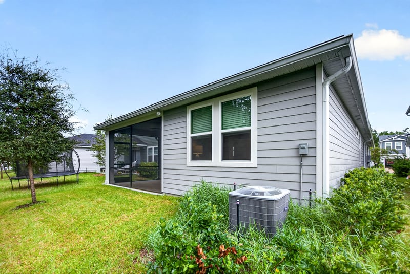 Screened porch exterior with AC unit and grass at 93 Lochloosa Ct, St. Johns, FL 32259