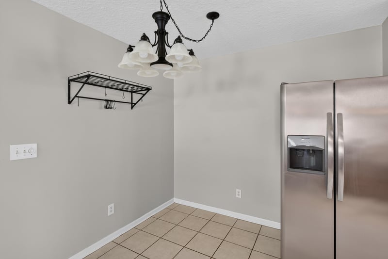 Kitchen nook with pendant light and refrigerator at 11669 Collins Creek Dr, Jacksonville, FL 32258