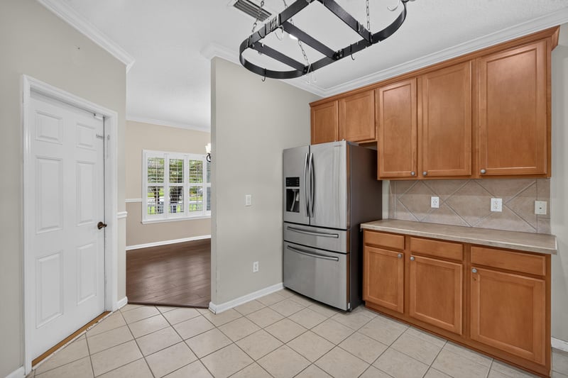Hallway with tile floor leading to the kitchen at 1493 Greyfield Dr, St. Augustine, FL 32092