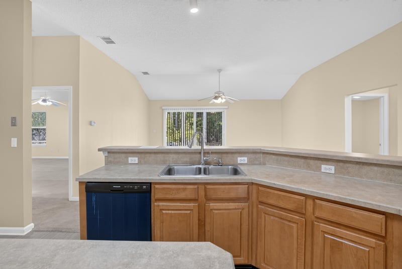 Kitchen sink and counter with vaulted ceiling at 299 John's Creek Pkwy, St. Augustine, FL 32092