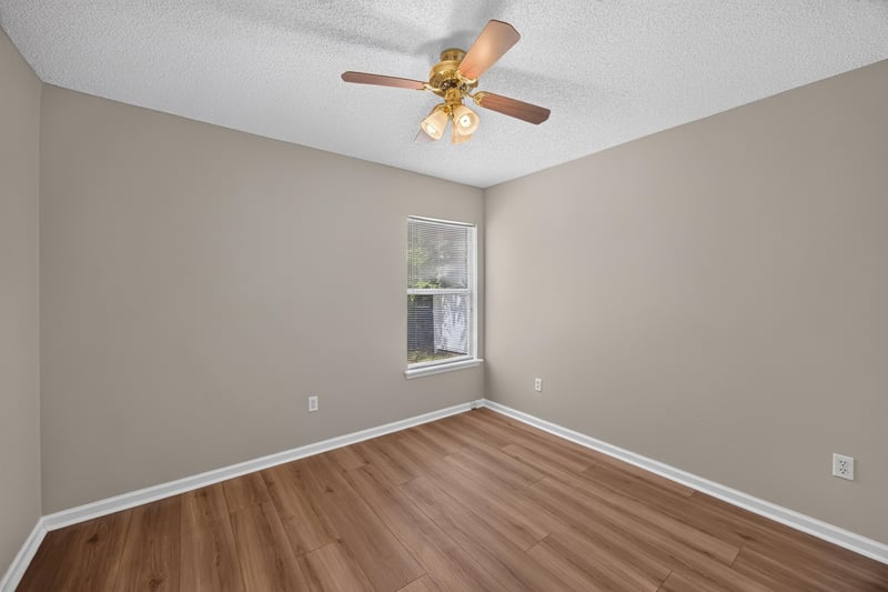 Bedroom with wood floor and window at 9256 Dale View Ln W, Jacksonville, FL 32225