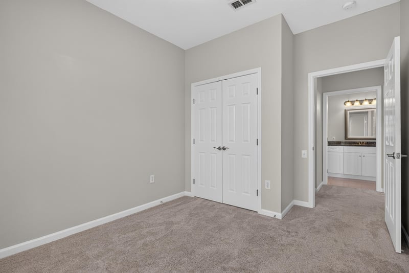 Bedroom with closet doors at 7990 Baymeadows Rd E #404, Jacksonville, FL 32256