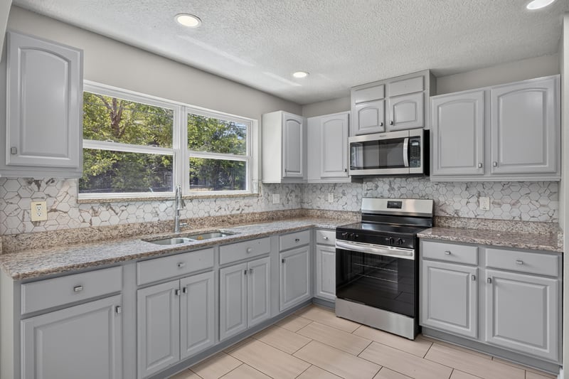 Kitchen with granite counters and window at 7015 Miss Muffet Ln N, Jacksonville, FL 32210