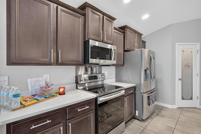 Kitchen upper cabinets and stainless range at 589 Seville Pkwy, St. Augustine, FL