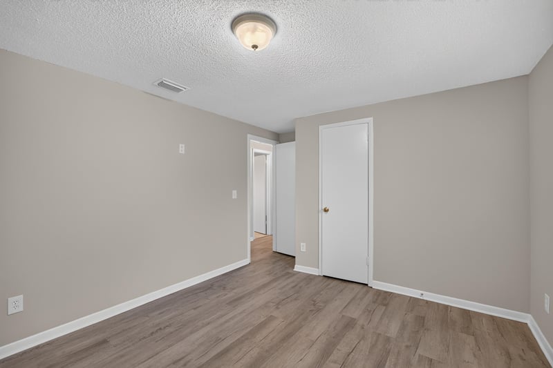 Hallway with doors and wood-look flooring at 1435 Undine Ave, Jacksonville, FL