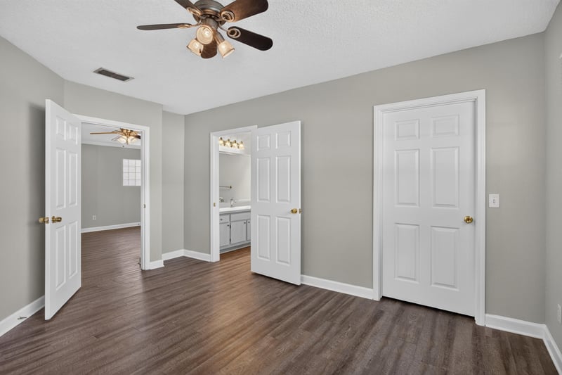 Bedroom with closet doors and hardwood floors at 1701 The Greens Way 1415, Jacksonville Beach, FL 32250