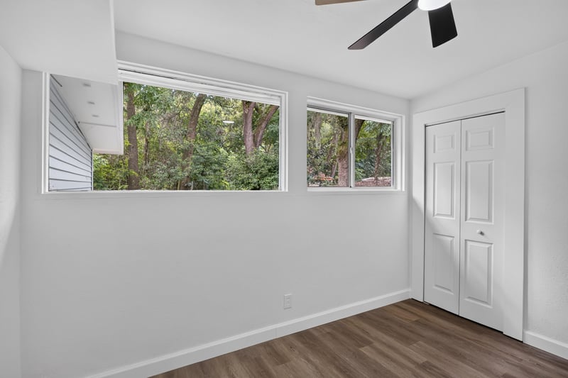 Bedroom with row of windows and closet door at 3113 Kline Rd, Jacksonville, FL 32246