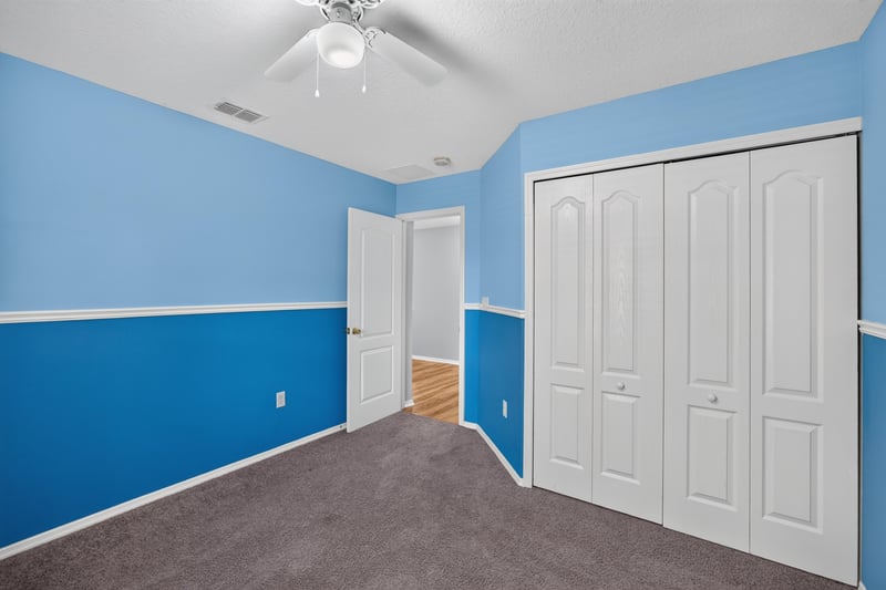 Empty bedroom with closet and blue walls at 7545 Lirope St, Jacksonville, FL 32244
