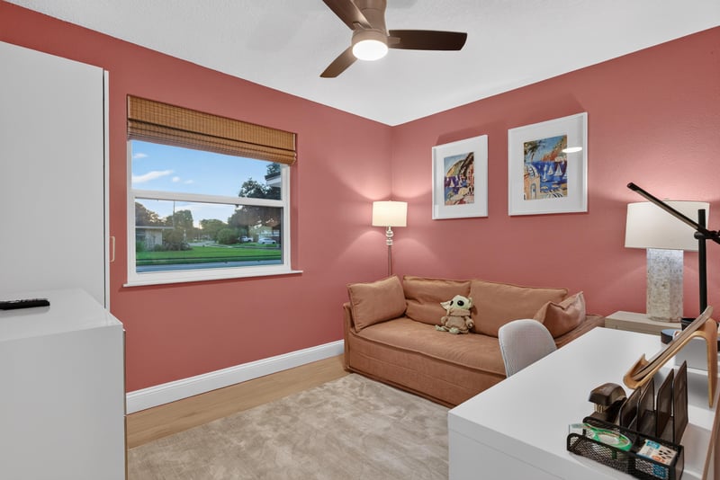 Bonus room with coral walls and sofa at 1525 8th St N, Jacksonville Beach, FL