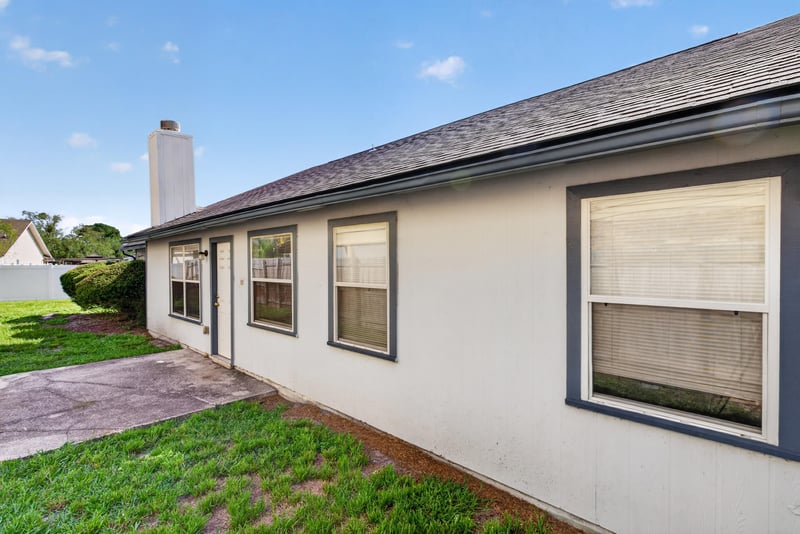 Rear exterior with chimney and windows at 400 Ashcroft Landing Dr, Jacksonville, FL 32225