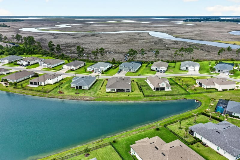 Drone view of a pond and surrounding homes in Fernandina Beach, FL