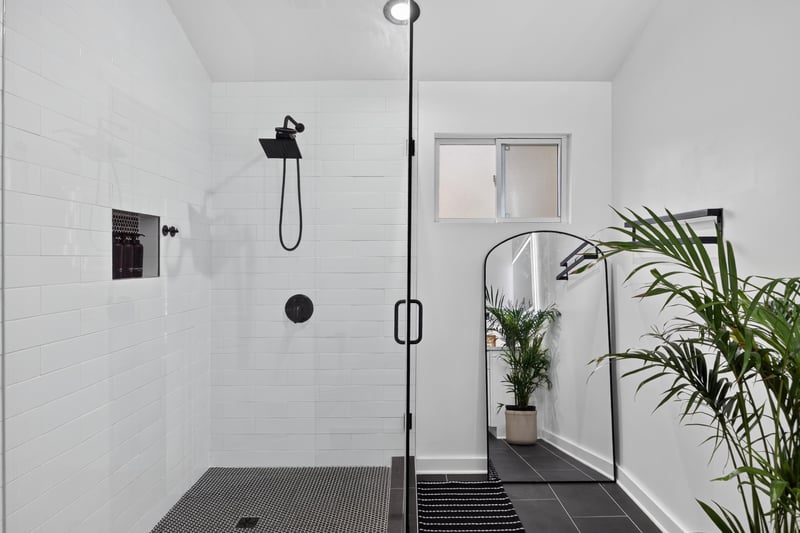 Tiled walk-in shower with black fixtures at 8921 Needlepoint Pl, Jacksonville, FL 32244