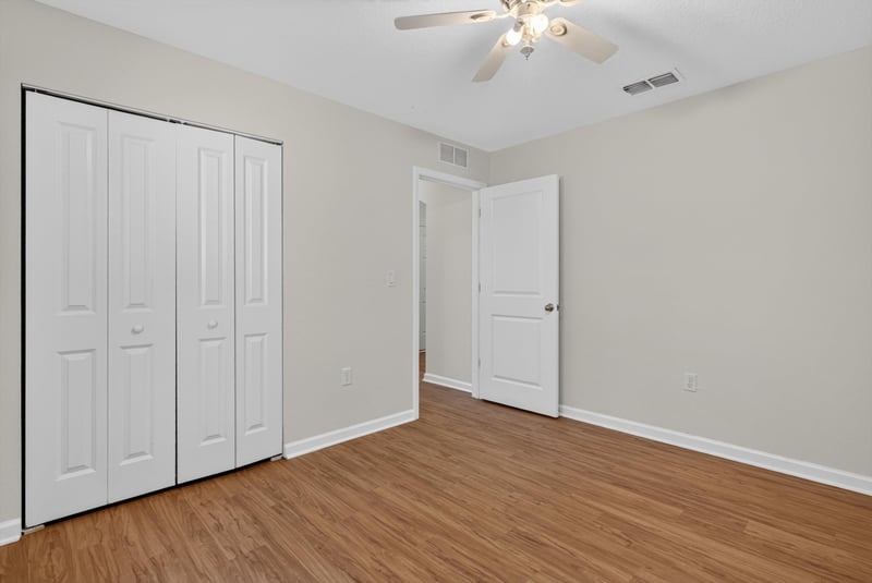Bedroom with closet doors and ceiling fan at 95221 Siena Ct, Fernandina Beach, FL 32034