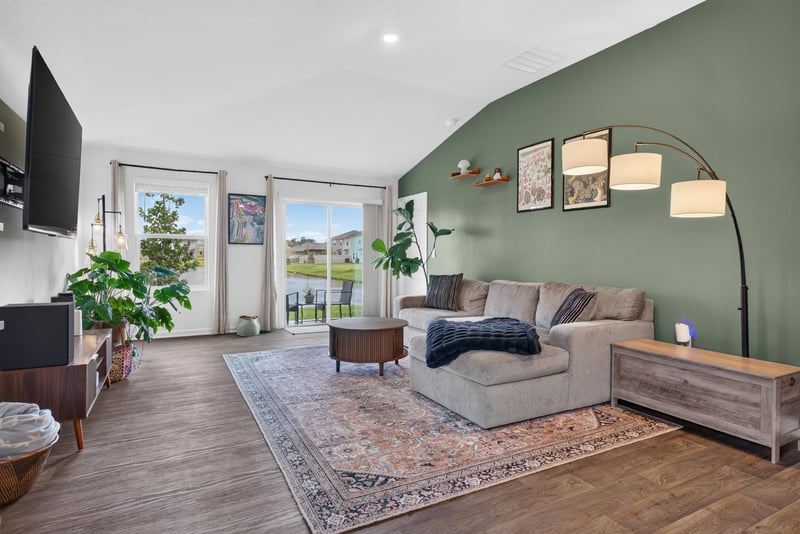 Living room with sofa and vaulted ceiling at 4276 Quaking St, Jacksonville, FL 32218