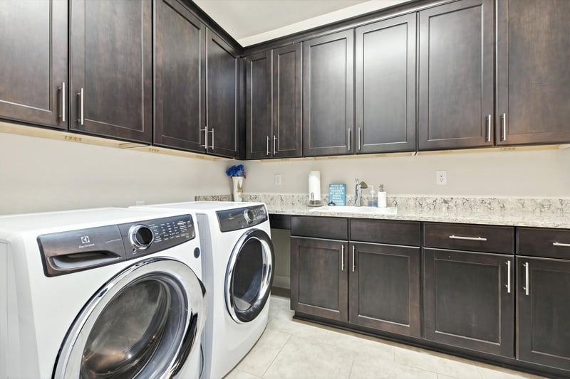 Laundry room with cabinetry, photographed by Megapixeler on Lucena Ln, Jacksonville, FL