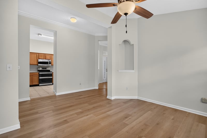Dining area with columns and wood floors at 2131 E Stone Creek Dr, Fleming Island, FL