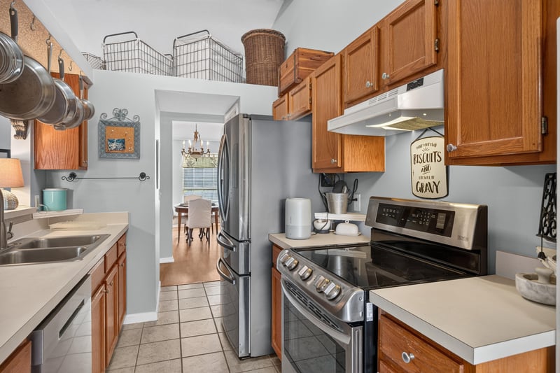 Kitchen with stainless range and wood cabinets at 4556 Shaky Leaf Ln N, Jacksonville, FL 32224