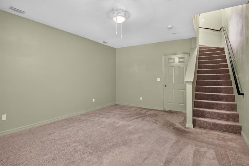 Upstairs room with view of staircase and ceiling fan at 342 E Ashley St, Jacksonville, FL 32202