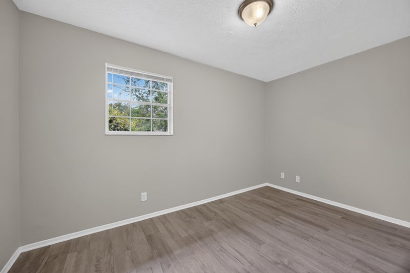 Empty bedroom with window and wood-look flooring at 1083 Stokes St, Jacksonville, FL