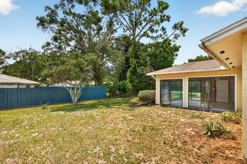 Side yard with trees and fence at 328 Palos Ct, St. Augustine, FL