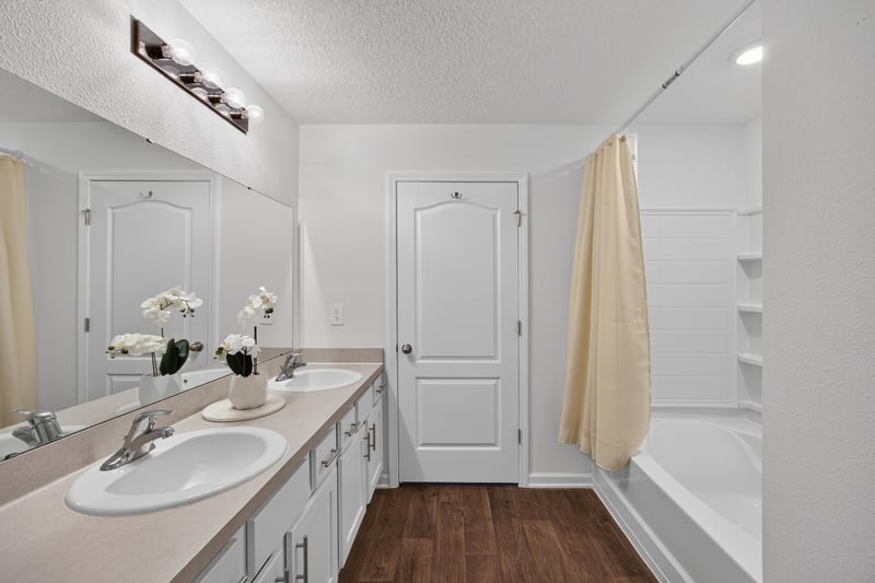 Bathroom with double vanity and shower at 65255 Frst Glen Ln, Yulee, FL 32097