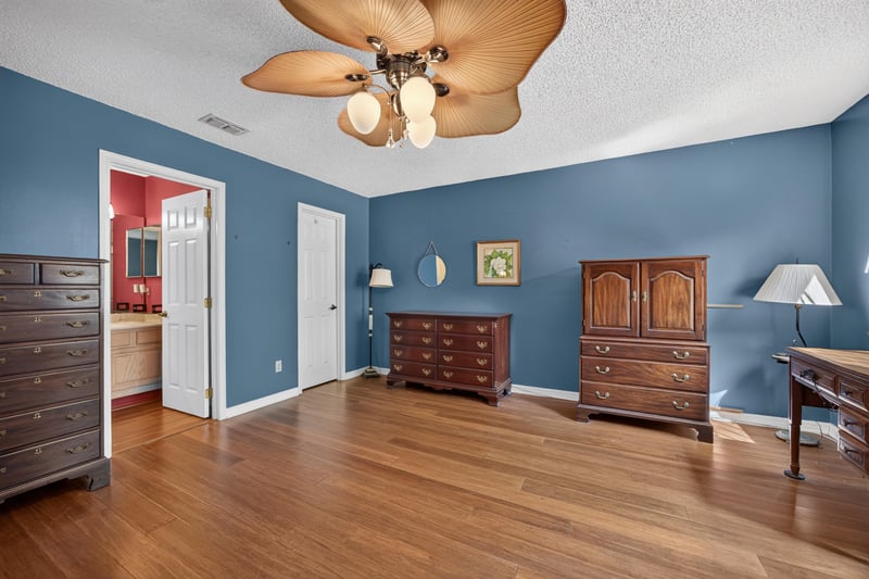 Bedroom with blue walls and multiple doors at 4837 Pareja Ct, Jacksonville, FL 32225
