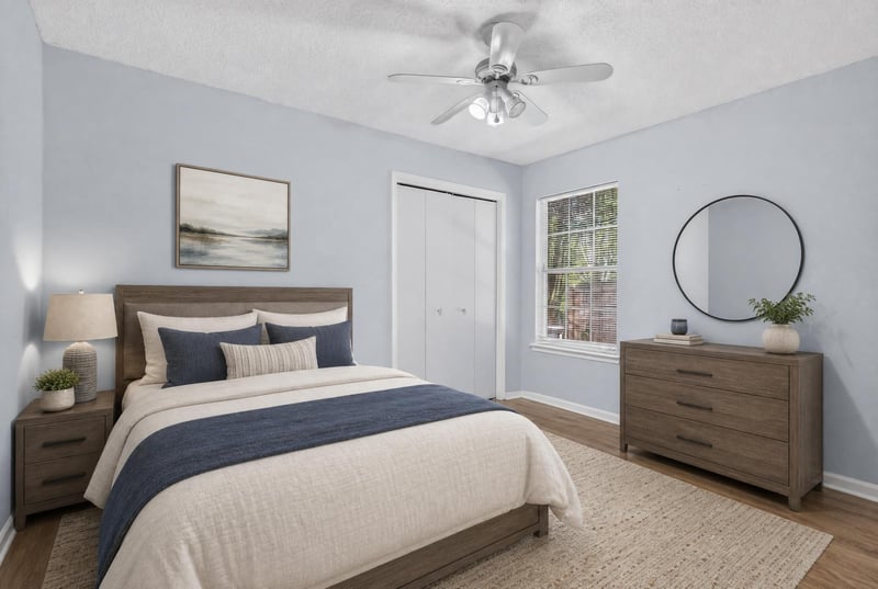 Bedroom with dresser and round mirror at 8680 Bandera Cir S, Jacksonville, FL 32244