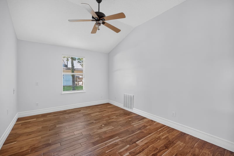 Bedroom with window and wood floors at 11675 Magnolia Estates Rd, Jacksonville, FL 32223