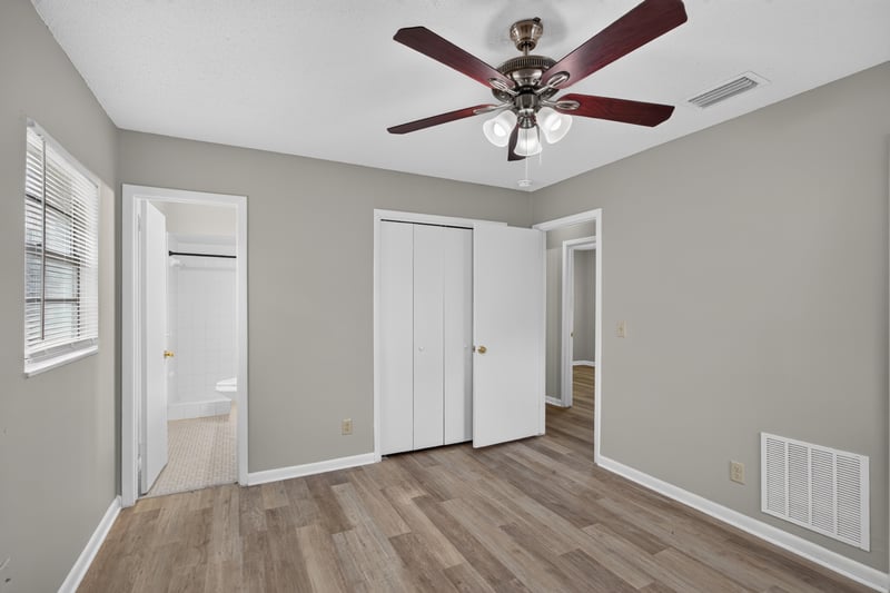 Bedroom with ceiling fan and two closets at 12351 Condor Dr