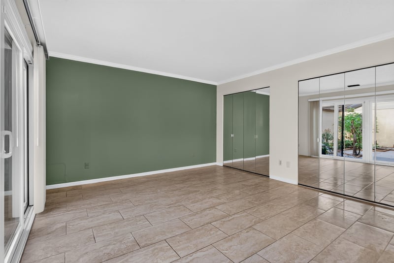 Living room with mirrored wall and green accent wall at 3515 Cormorant Branch Ct, Jacksonville, FL