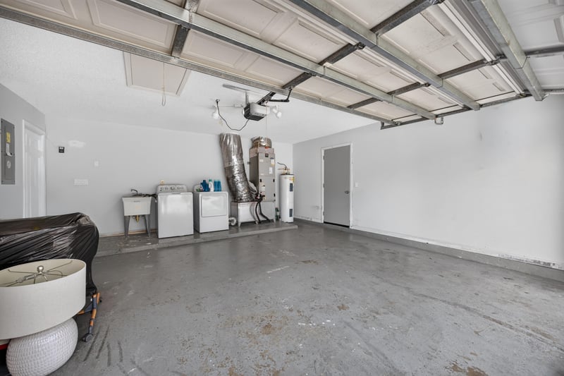 Garage with washer, dryer, and water heater at 8921 Needlepoint Pl, Jacksonville, FL 32244