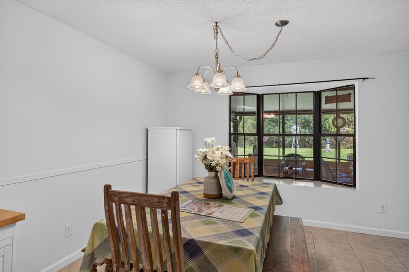 Dining area with window and table setting at 2435 Range Line Rd, Middleburg, FL