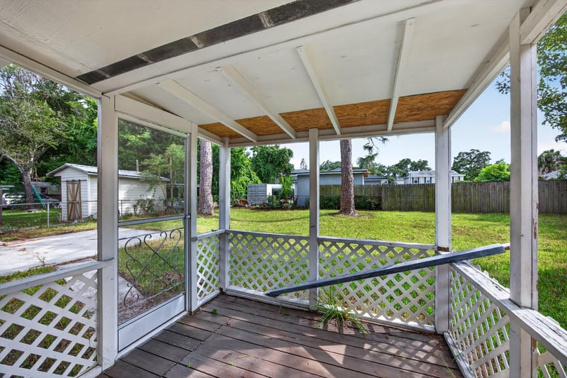 Covered screened porch with lattice railing at 87 Saratoga Cir S, Atlantic Beach, FL