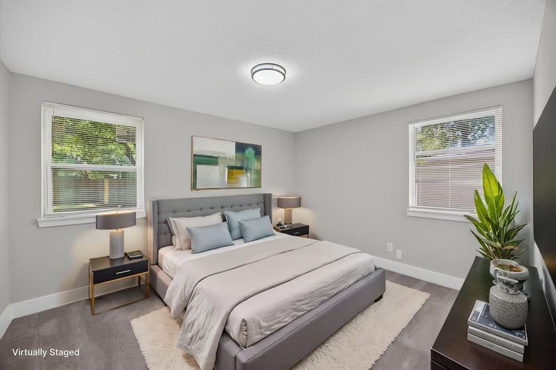 Bedroom with staged bed and natural light at 6238 Randia Dr, Jacksonville, FL 32210
