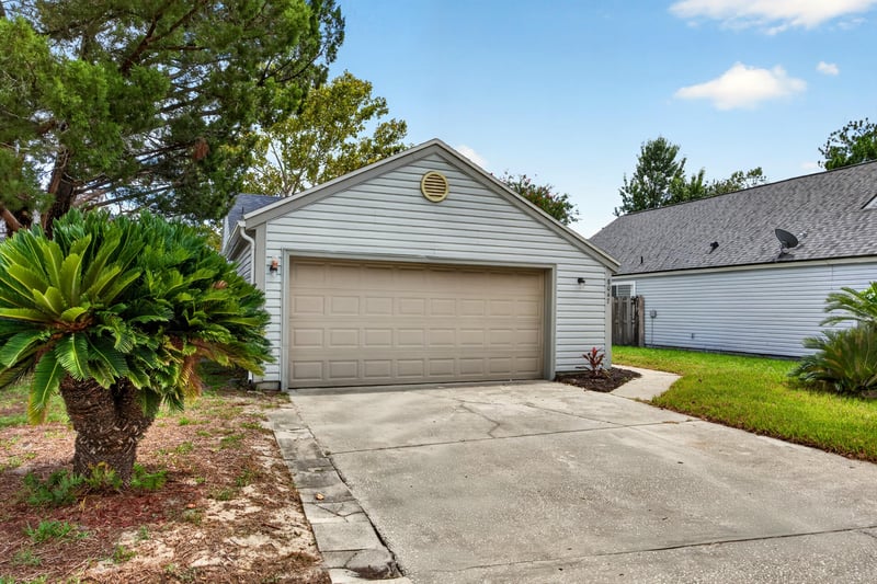 Front exterior with palm landscaping and garage at 8047 Mactavish Way E, Jacksonville, FL 32244