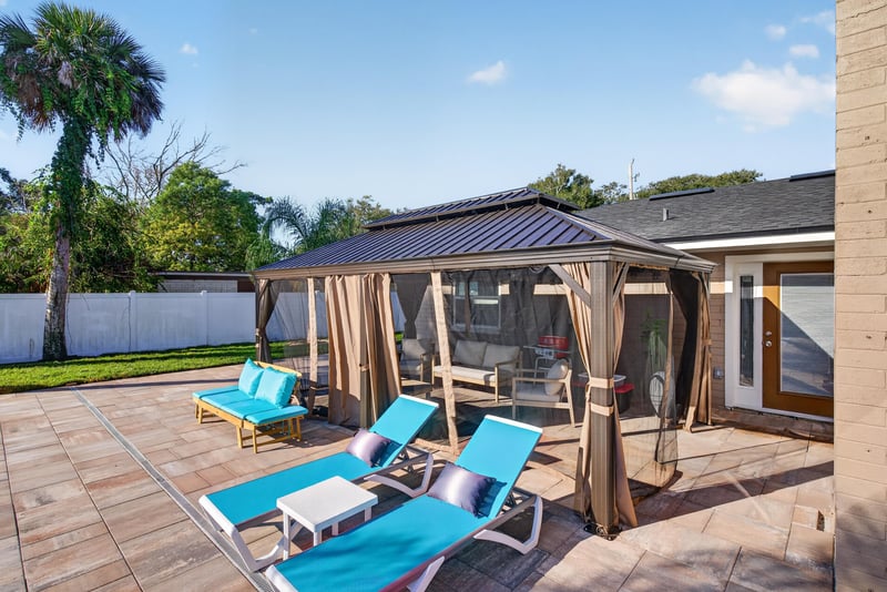 Covered patio with lounge chairs at 1525 8th St N, Jacksonville Beach, FL