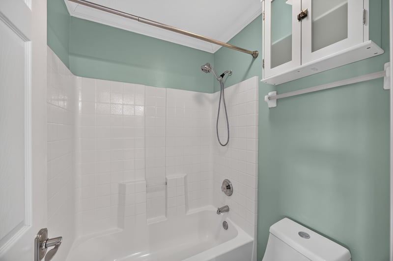 Bathroom with tub-shower combo and tile accent wall at 1493 Greyfield Dr, St. Augustine, FL 32092