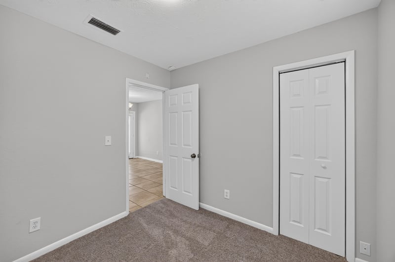 Hallway with closet door and carpet flooring at 7453 Jade Dr N, Jacksonville, FL 32210