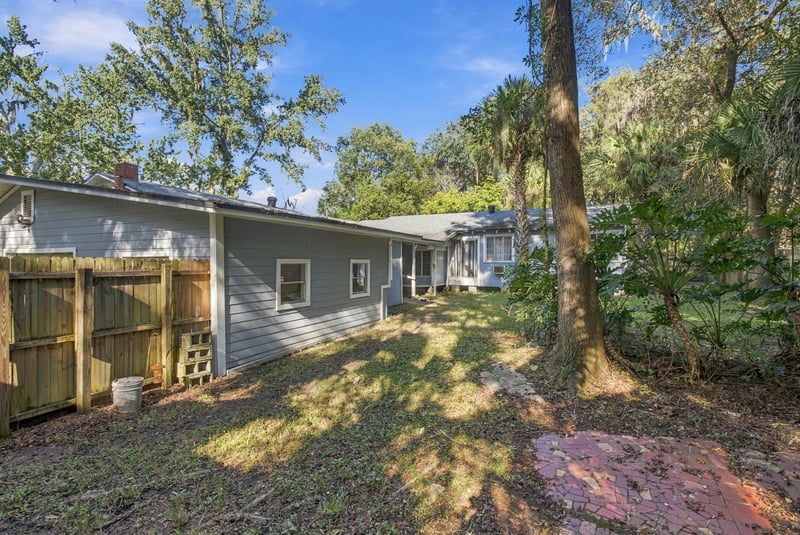 Backyard view with shed and tree cover at 1807 Idlewild Ave, Green Cove Springs, FL