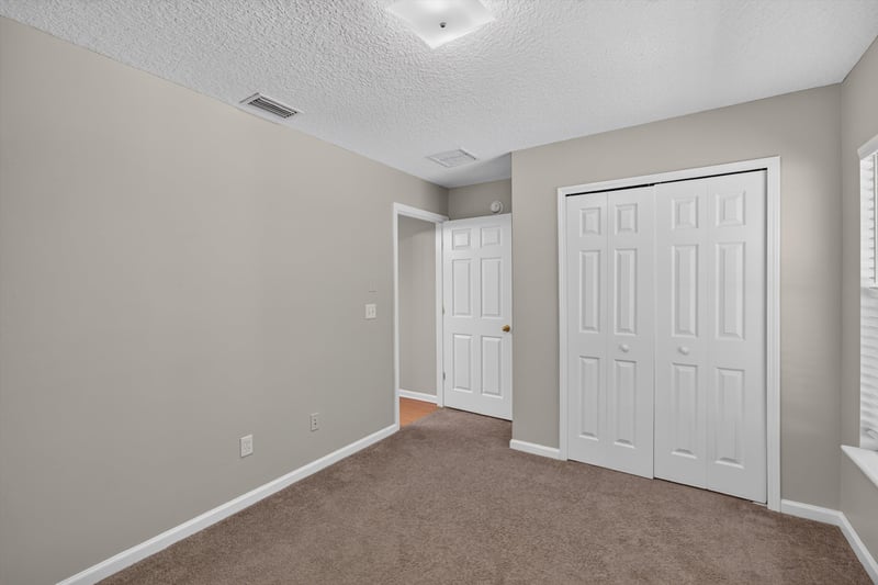 Carpeted bedroom with closet at 14147 Fish Eagle Dr E, Jacksonville, FL 32226